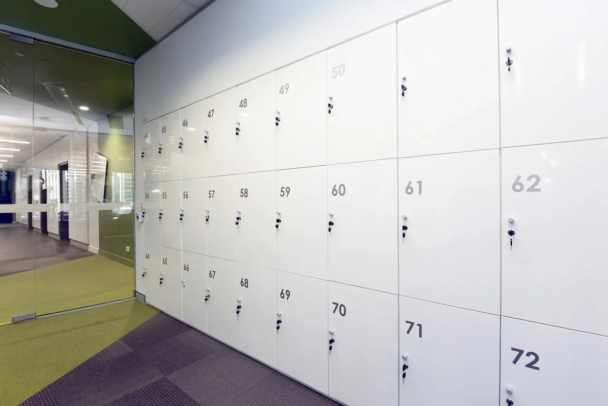 White numbered lockers in an office corridor